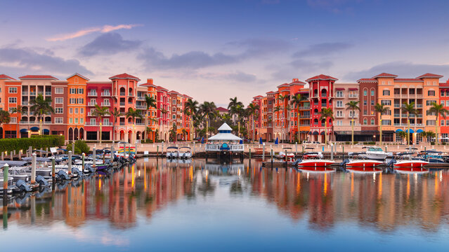 Naples, Florida, USA. Cityscape image of Naples, Florida with reflection of the city skyline in the water at beautiful sunrise.