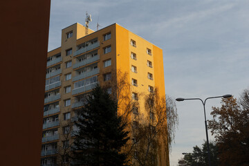 A tall, impressive building featuring a prominent satellite dish situated on the very top of it,...