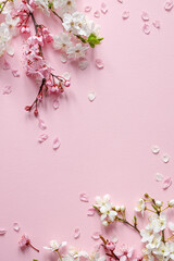 Spring easter background in shades of pink with blooming branches and sugar easter eggs. 