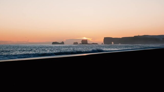 Iceland Reynisfjara black beach at sunset.