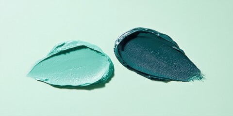 Obraz premium Two drops of mint and dark green oil paint on a white background, macro