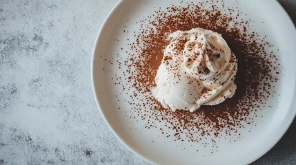 Minimalist shot of coffee semifreddo topped with whipped cream and a sprinkle of cocoa powder