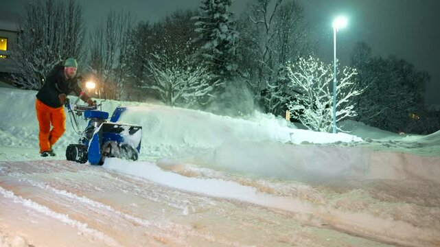 Cold blizzard weather, manual effort work, outdoor evening scenery