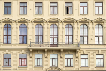 Architectural details of a historic building in Saint Petersburg showcasing elegant design and large windows during daylight