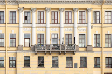 Historic architecture stands out in Saint Petersburg with elegant columns and a charming balcony on a clear day
