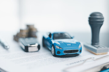 Approved car loan application with car key, rubber stamp and calculator concept. financial document on wooden table. Asset approval purchases to buy car. Ideas for car buying checklist loan tax