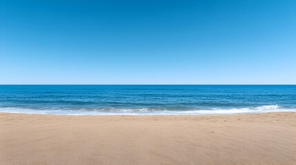 Empty beach under a vibrant blue sky.  Ocean waves gently lap the shore
