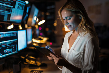 Beautiful executive working with digital tablet while working in a modern office.