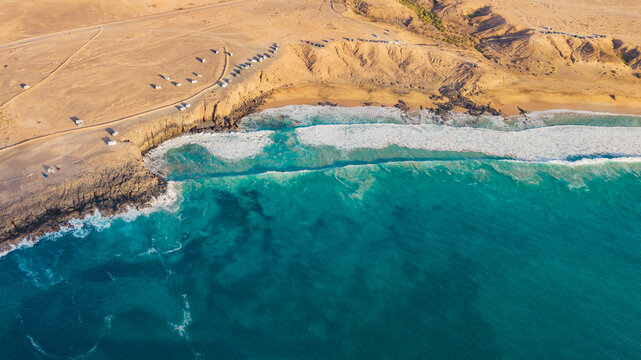 Aerial view of cotillo beach with beautiful waves and azure waters, Fuerteventura Island, Canary Islands, Spain.