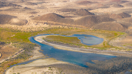 Aerial view of a beautiful volcanic landscape with green and sandy patterns, Lobos island, Canary Islands, Spain.