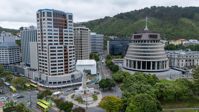 Aerial view of beehive parliament and modern buildings surrounded by greenery and urban landscape, Pipitea, Wellington, New Zealand.