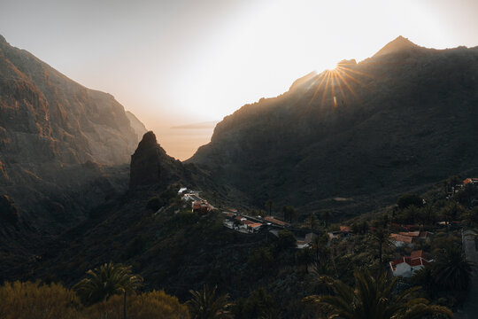 Aerial view of picturesque village nestled in a tranquil valley with majestic mountains at sunset, Masca, Santa Cruz de Tenerife, Canary Islands.