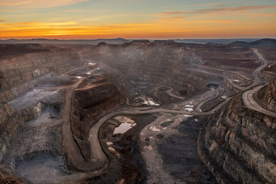 Aerial view of the majestic Rio Tinto canyon at sunset with rugged rock formations and winding roads, Minas de Riotinto, provincia de Huelva, Spain.