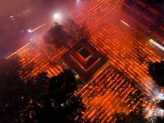 Aerial view of a vibrant festival with glowing lamps and smoke at Shri Shri Loknath Brahmachari Ashram, Narayanganj, Dhaka, Bangladesh.