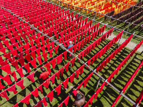 Araihazar, Bangladesh - 09 November 2024: Aerial view of workers engaged in vibrant laundry activities with colorful yarn, Araihazar, Dhaka, Bangladesh.