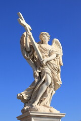 Obraz premium Angel with the Cross Statue with Bright Blue Sky At Ponte Sant'Angelo Bridge in Rome, Italy, March 2025