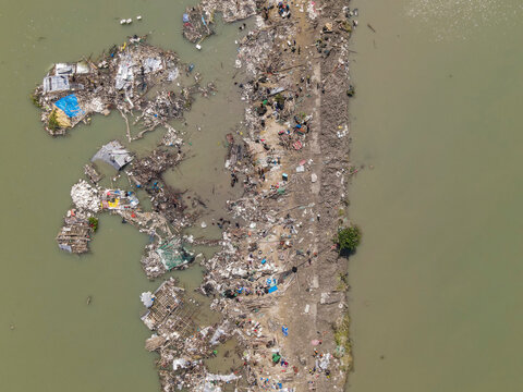 Aerial view of destroyed houses and debris in a fishing village after cyclone Sitrang, Potenga, Chittagong, Bangladesh.