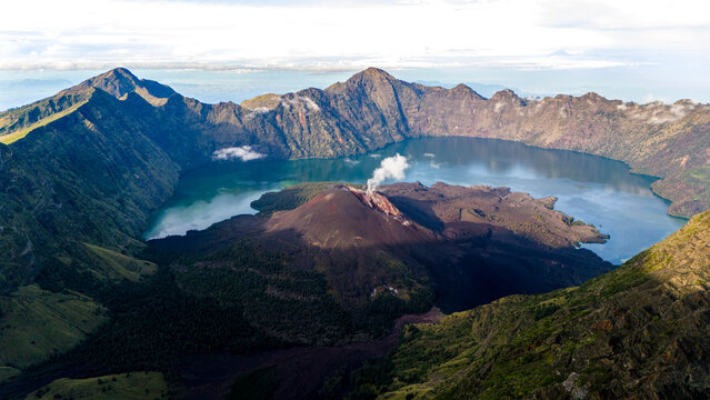 Aerial drone view of the top of active Rinjani volcano during sunrise on the island of Lombok, Indonesia