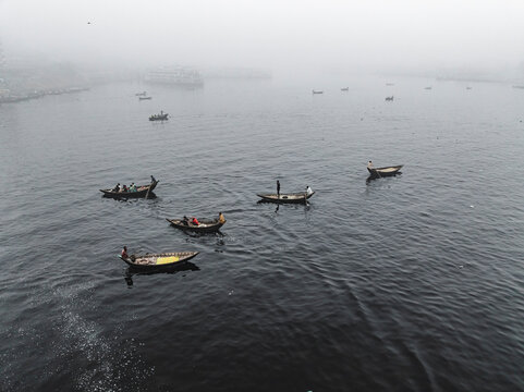 Aerial view of boats at a vibrant vegetable market along the Buriganga River, Keraniganj, Dhaka, Bangladesh.