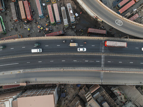 Aerial view of busy junction road with a bus station and various vehicles, Gendaria, Dhaka, Bangladesh.