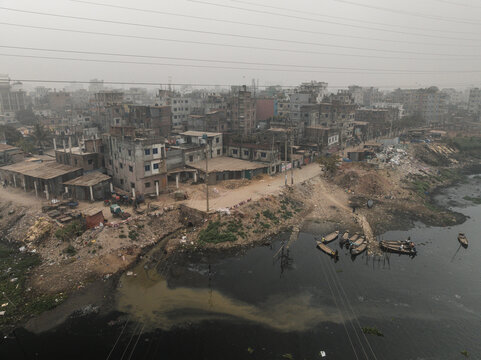 Aerial view of the beautiful Buriganga river flowing through the urban landscape of Dhaka with residential districts and buildings, Lalbagh Thana, Dhaka, Bangladesh.
