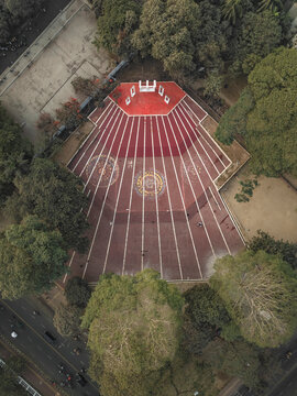 Aerial view of central shaheed minar surrounded by greenery and urban landscape, Shahbag, Dhaka, Bangladesh.