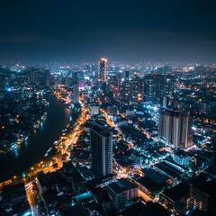 Fototapeta premium Night cityscape panorama. Urban lights glow over a sprawling metropolis, featuring a river running through the heart of the city. Modern towers and older buildings intermingle, highlighting