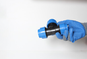 plumbing clutch in a blue glove