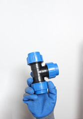 plumbing clutch in a blue glove