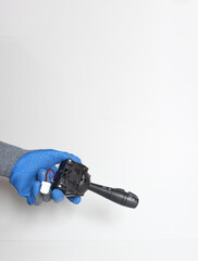 car switching handle in a hand in a blue glove