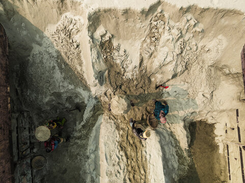 Aerial view of people working at an industrial construction site with cement industries and machinery, Darus Salam Thana, Dhaka, Bangladesh.