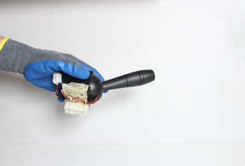car switching handle in a hand in a blue glove