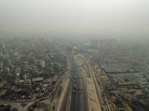 Aerial view of bustling urban skyline with high-rise buildings and busy roads, Amin Bazar, Savar, Dhaka, Bangladesh.