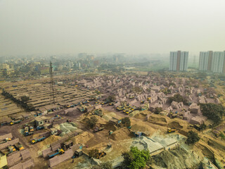 Aerial view of industrial cement industries and urban development with buildings and factories, Amin Bazar, Savar, Dhaka, Bangladesh.