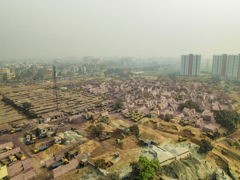 Aerial view of industrial cement industries and urban development with buildings and factories, Amin Bazar, Savar, Dhaka, Bangladesh.