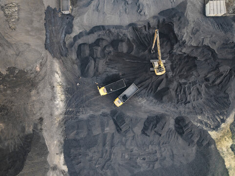 Aerial view of coal factory with cranes and excavators in operation, Amin Bazar, Savar, Dhaka, Bangladesh.