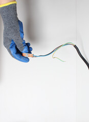 Wires for wires in a hand in a blue glove