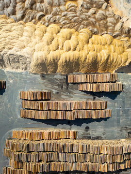 Aerial view of an industrial wood processing area with stacked wood and wood shavings, Wolfsberg, Carinthia, Austria.