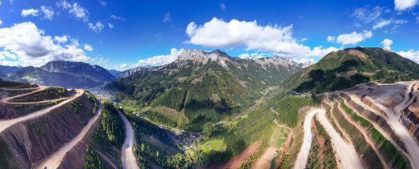 Aerial view of Erzberg iron ore mine surrounded by mountain landscape and rugged terrain, Eisenerz, Styria, Austria.
