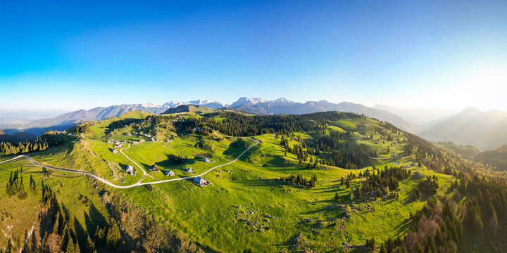 Aerial view of picturesque alpine pasture with chalets and cabins in a tranquil mountain landscape, Velika Planina, Kamnik, Slovenia.
