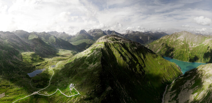 Aerial view of Piz Cavradi and Lai da Curnera surrounded by a lush valley and majestic mountains, Rueras, Uri Canton, Switzerland.