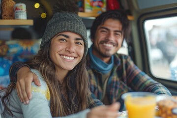 Fototapeta premium Happy Latino couple enjoying a meal in a cozy camper van, radiating warmth and joy.