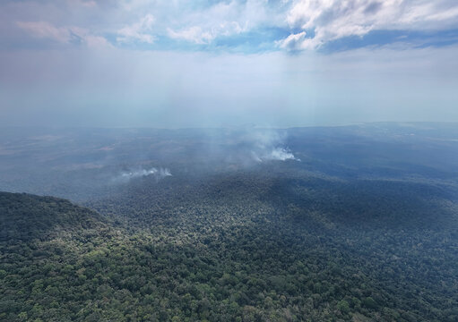 Aerial view of bokor mountain with fires in the forest and lush greenery, Preaek Tnoat, Tuek Chhou District, Kampot, Cambodia.