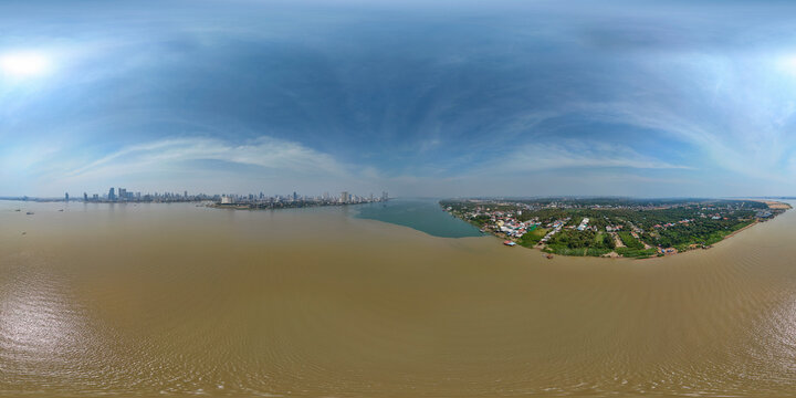 Aerial view of serene Mekong and Tonle Sap river with tranquil cityscape and expansive greenery, Akreiy Ksatr, Kandal, Cambodia.