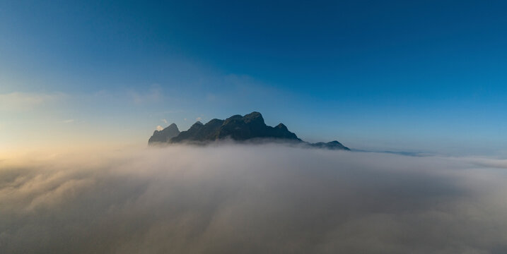 Aerial view of Nong Khiaw above the fog with majestic mountains and serene sky, Ngoy District, Luang Prabang, Laos.