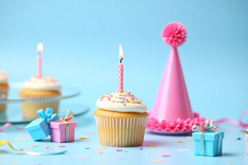 cupcake with a lit candle sitting on top of it