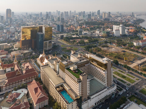Aerial view of naga casino and high rise buildings in a bustling urban landscape with roads and a river, Chamkarmon District, Phnom Penh, Cambodia.