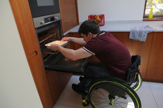 Man in wheelchair baking in kitchen