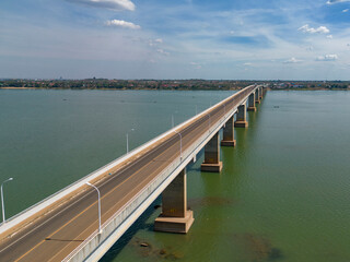 Aerial view of the beautiful Mekong bridge spanning the river with clear water and serene landscape, Thala Barivat District, Stung Treng, Cambodia.