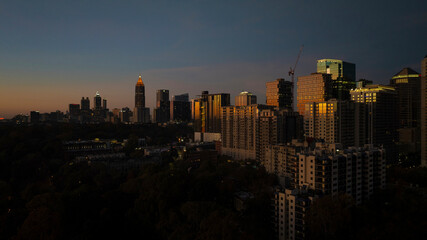 Aerial view of vibrant skyline with illuminated skyscrapers and bustling cityscape at night, Midtown, Atlanta, Georgia, United States.